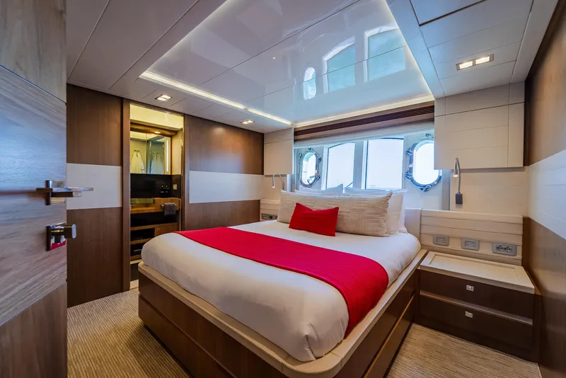 Slide: The Image of Luxurious yacht bedroom with modern design, featuring a comfortable bed and elegant wood finishes. - 23