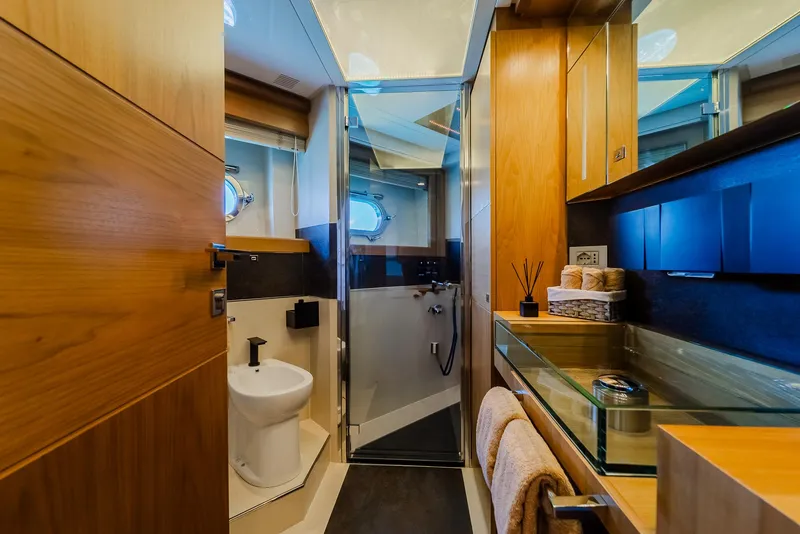 Slide: The Image of Luxurious yacht bathroom with modern fixtures, glass shower, and wooden cabinetry, Custom Line 100, 2012. - 26