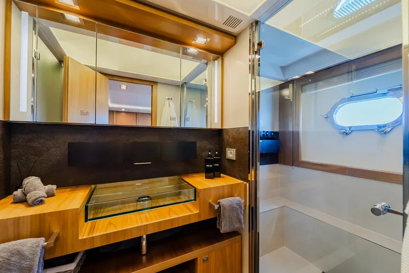 Slide: The Image of Luxurious yacht bathroom with glass sink, wooden accents, and modern fixtures, Custom Line 100, 2012. - 28