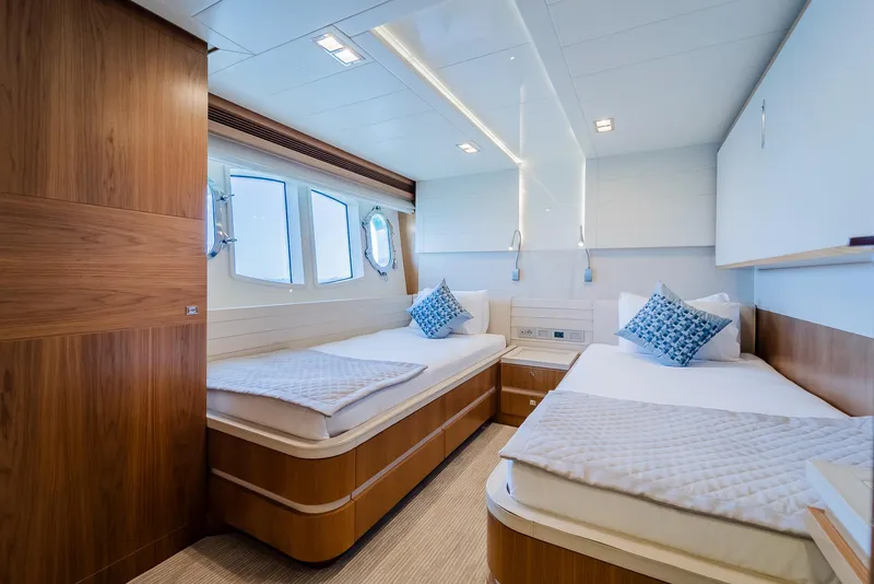 Slide: The Image of Luxurious twin cabin interior on a 2012 Custom Line 100 yacht, featuring modern design and comfort. - 29