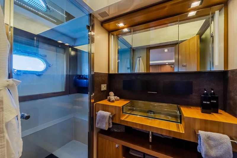 Slide: The Image of Luxurious yacht bathroom with glass shower, modern sink, and wooden cabinetry, Custom Line 100, 2012. - 30