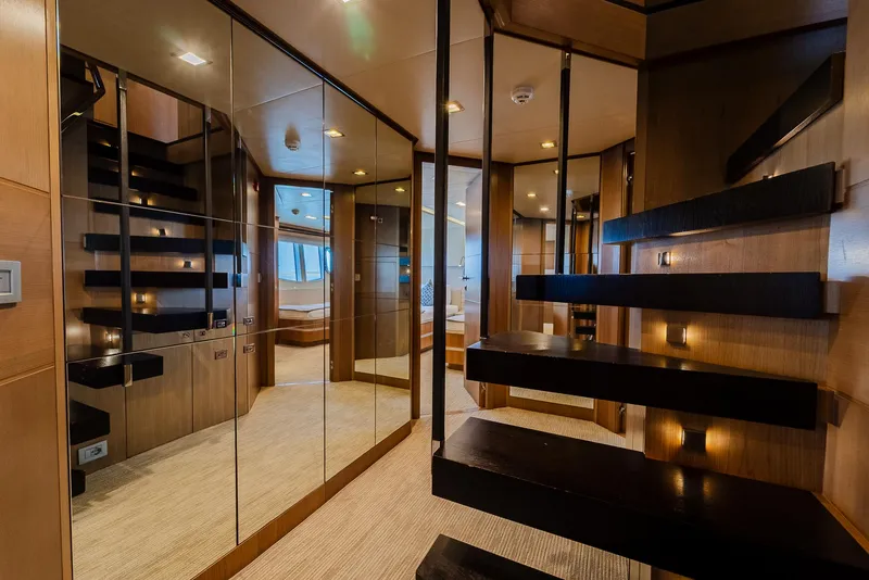 Slide: The Image of Luxurious yacht interior with modern staircase, mirrored walls, and elegant wood finishes, Custom Line 100, 2012. - 31