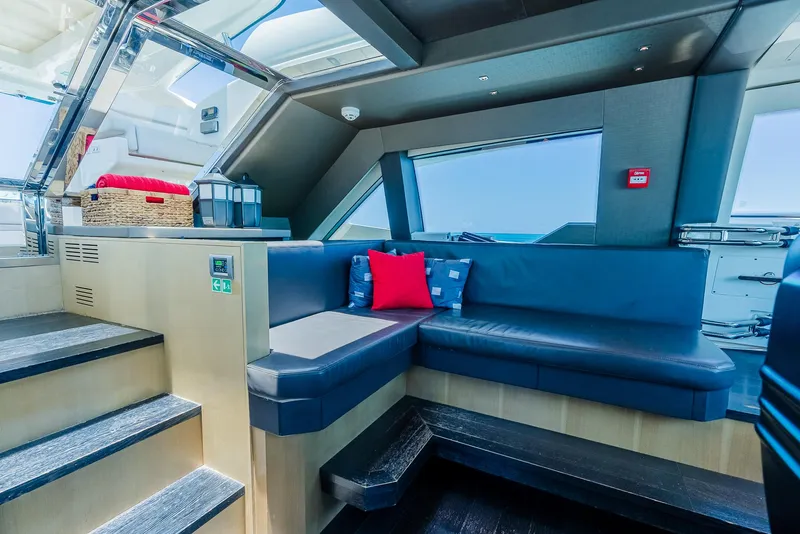 Slide: The Image of Luxurious yacht interior with blue seating, red cushions, and modern design, Custom Line 100, 2012. - 37