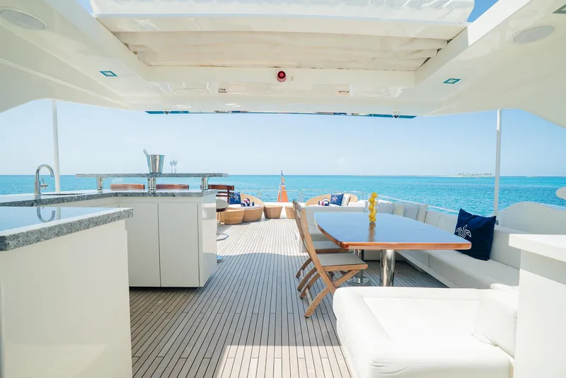Slide: The Image of Luxurious yacht deck with seating, dining area, and ocean view, Custom Line 100, 2012 model. - 40