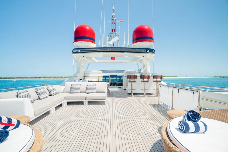 Slide: The Image of Luxurious 2012 Custom Line 100 yacht deck with seating, ocean view, and clear blue sky. - 44