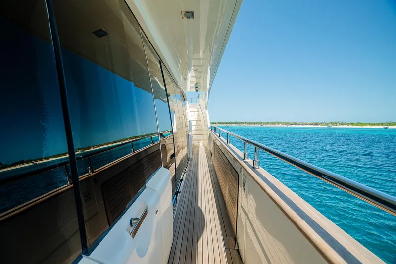 Slide: The Image of Side deck of a 2012 Custom Line 100 yacht cruising on clear blue waters. - 45