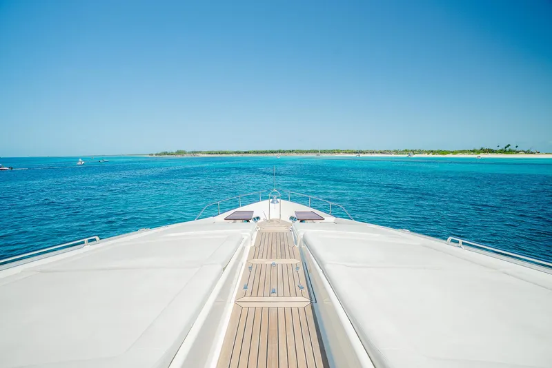 Slide: The Image of Bow view of 2012 Custom Line 100 yacht cruising in clear blue waters. - 47
