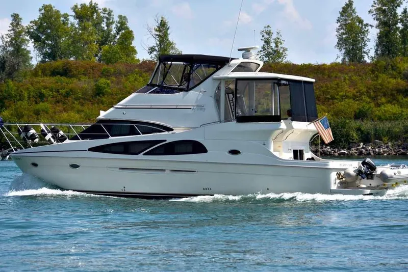 The Image of 2006 Carver 41 Cockpit Motor Yacht cruising on a serene waterway. - 0