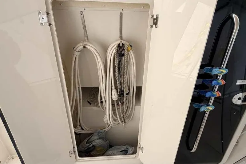 Slide: The Image of Storage compartment with coiled ropes on a 2006 Carver 41 Cockpit Motor Yacht. - 11