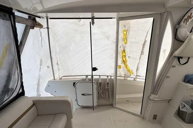 Slide: The Image of Staircase inside 2006 Carver 41 Cockpit Motor Yacht, featuring white steps and sleek design. - 12