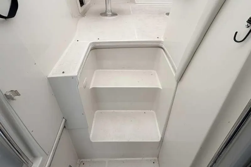 Slide: The Image of 2006 Carver 41 Cockpit Motor Yacht under protective cover, showcasing cockpit and seating area. - 13