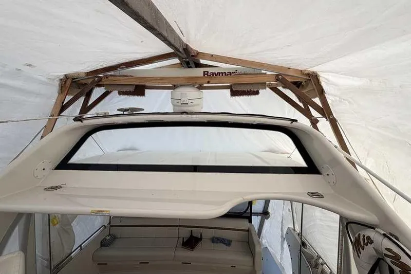 Slide: The Image of Interior of 2006 Carver 41 Cockpit Motor Yacht with beige seating and helm controls. - 14