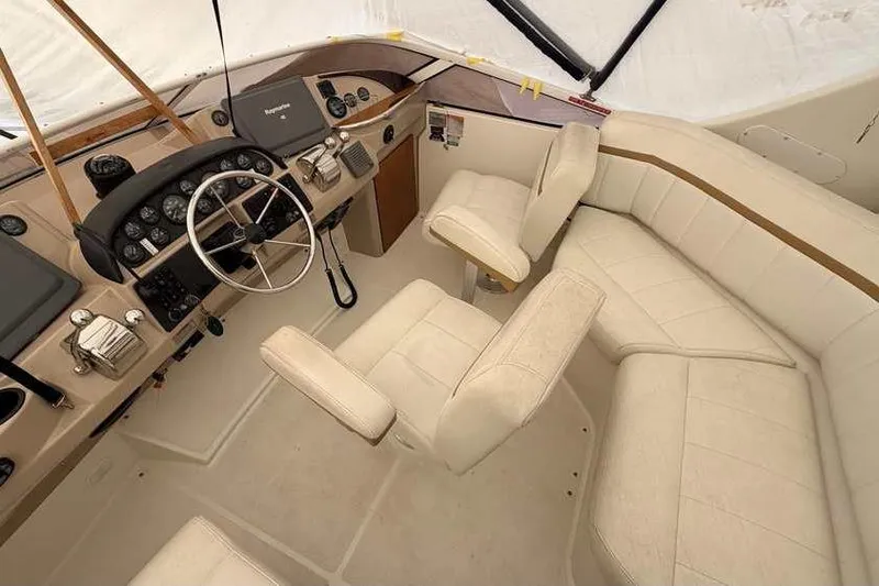 Slide: The Image of 2006 Carver 41 Cockpit Motor Yacht interior with white seating and steering wheel. - 15