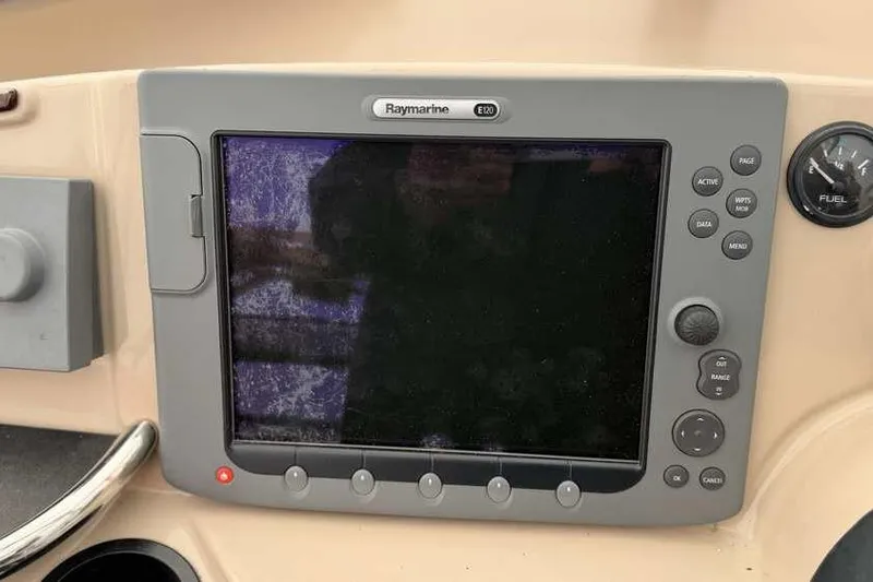 Slide: The Image of 2006 Carver 41 Cockpit Motor Yacht under protective cover, showcasing deck and equipment. - 23