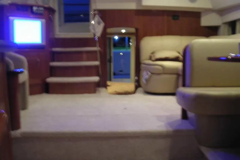 Slide: The Image of 2006 Carver 41 Cockpit Motor Yacht interior with kitchenette, featuring wood cabinetry and modern appliances. - 27