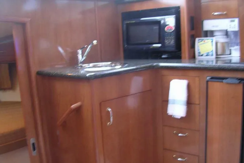 Slide: The Image of Interior dining area of 2006 Carver 41 Cockpit Motor Yacht with table setting. - 29