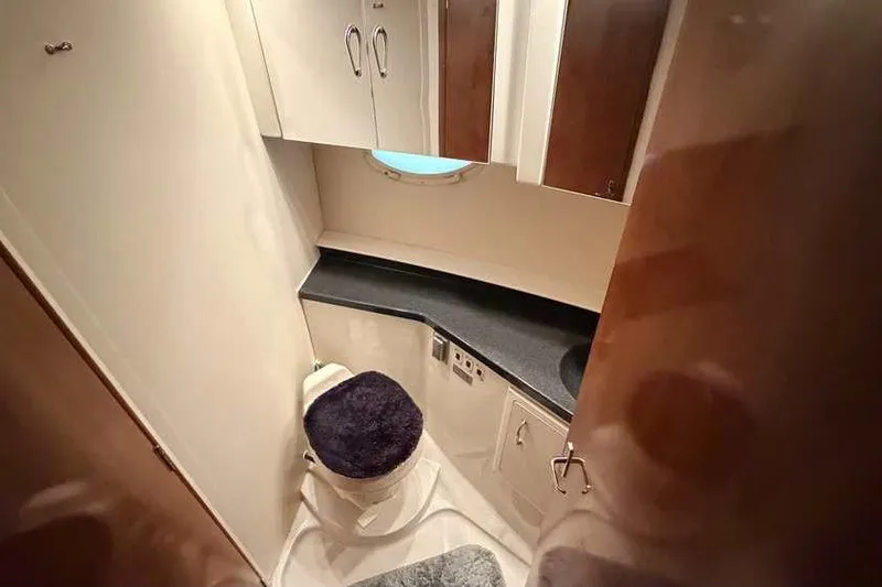 Slide: The Image of Interior of 2006 Carver 41 Cockpit Motor Yacht with wood cabinetry and porthole window. - 33