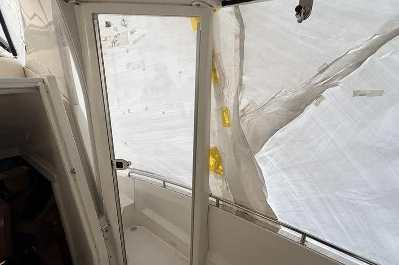 Slide: The Image of 2006 Carver 41 Cockpit Motor Yacht interior with helm and seating area. - 7