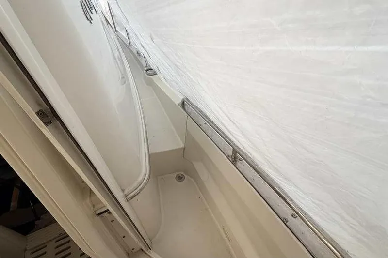 Slide: The Image of 2006 Carver 41 Cockpit Motor Yacht interior with white seating and railing. - 9