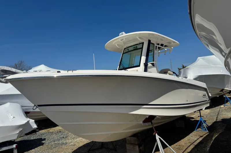 The Image of 2026 Boston Whaler 250 Outrage boat displayed outdoors under clear blue sky. - 0