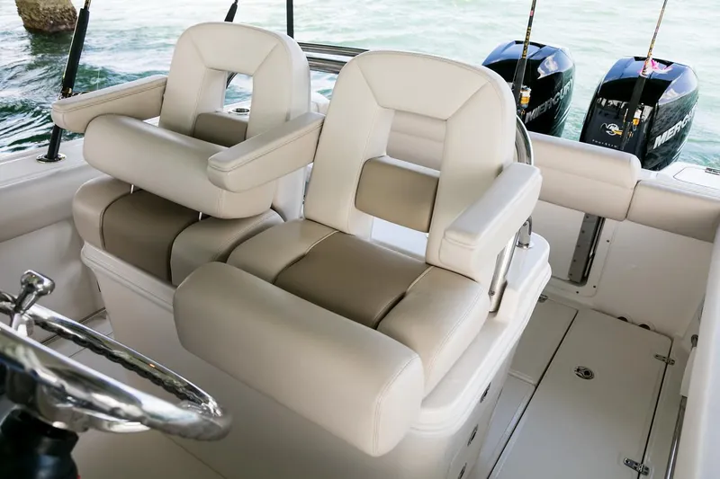 Slide: The Image of Manufacturer Provided Image: 2025 Boston Whaler 250 Outrage boat interior with dual seats and twin engines. - 17