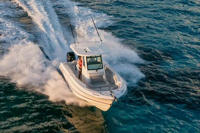 Slide: The Image of Manufacturer Provided Image: 2025 Boston Whaler 250 Outrage speeding on open water. - 5