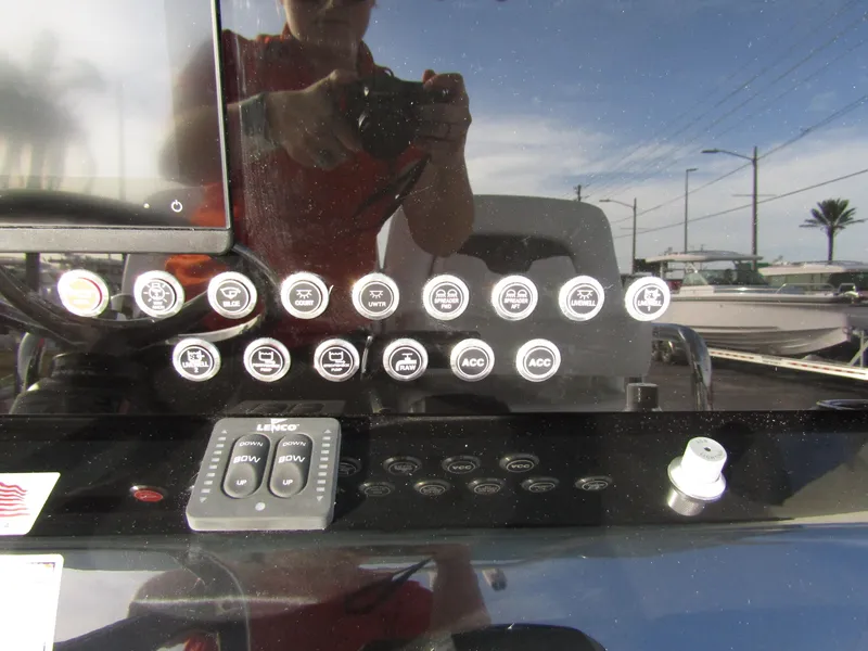 Slide: The Image of Control panel of 2025 Wellcraft 243 Fisherman boat with various buttons and switches. - 20
