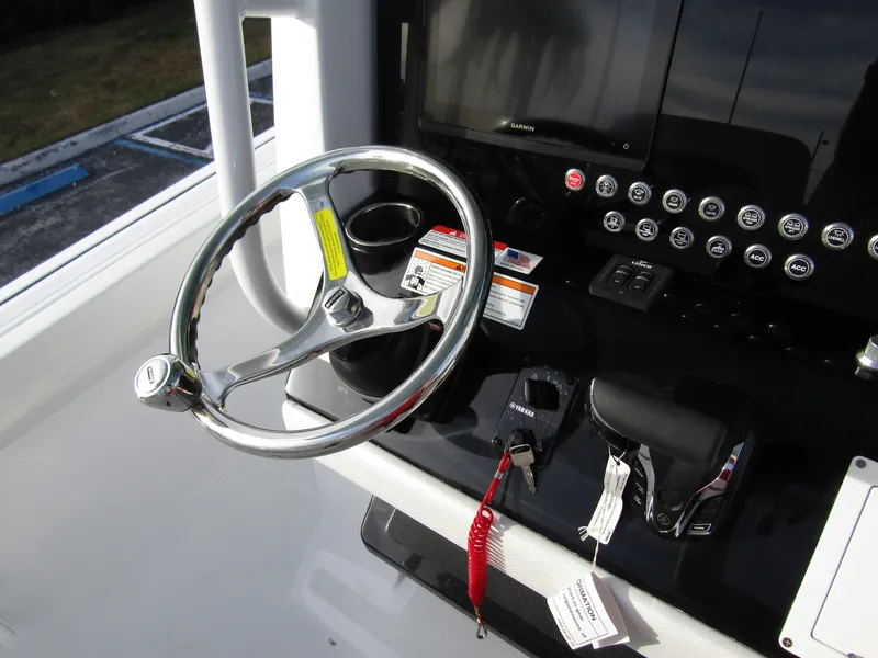Slide: The Image of Steering console of 2025 Wellcraft 243 Fisherman boat with controls and display. - 23