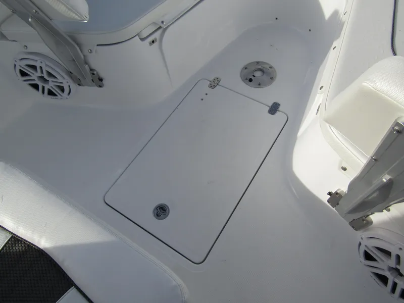 Slide: The Image of 2025 Wellcraft 243 Fisherman boat interior, featuring a clean, white deck with storage hatch. - 14