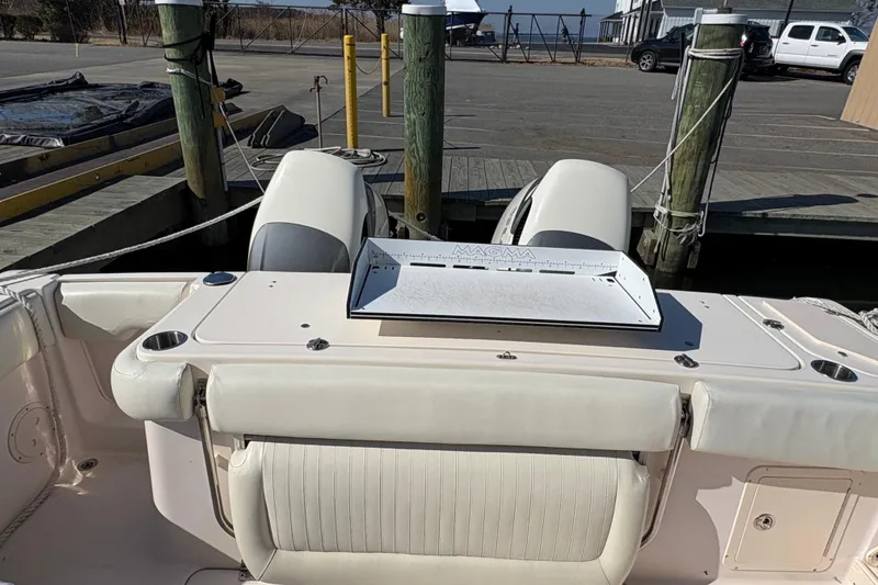 Slide: The Image of 2008 Grady-White Canyon 336 boat docked, featuring a Magma grill on the deck. - 10