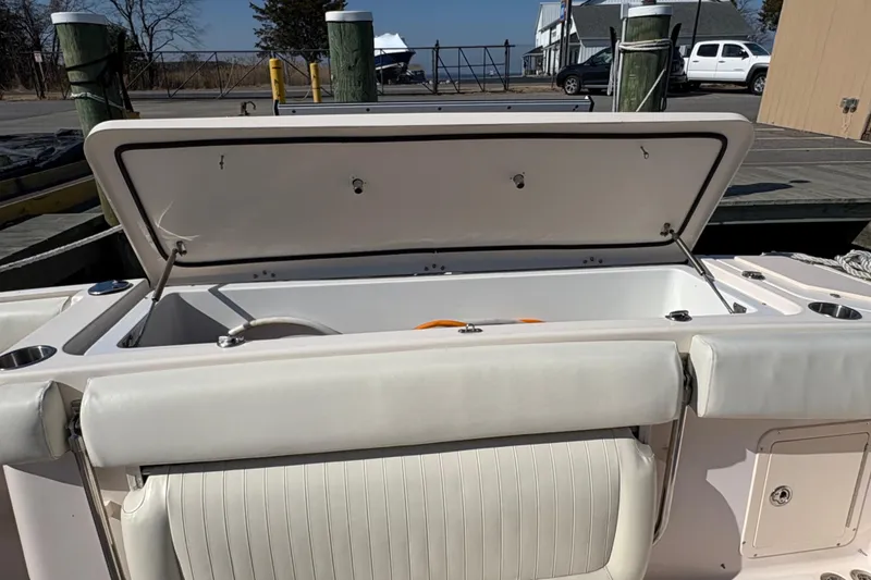 Slide: The Image of 2008 Grady-White Canyon 336 boat with open storage compartment at dock. - 11