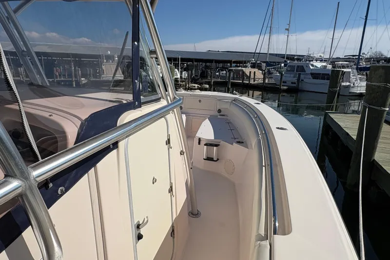 Slide: The Image of 2008 Grady-White Canyon 336 boat docked at marina, showcasing sleek design and spacious deck. - 12