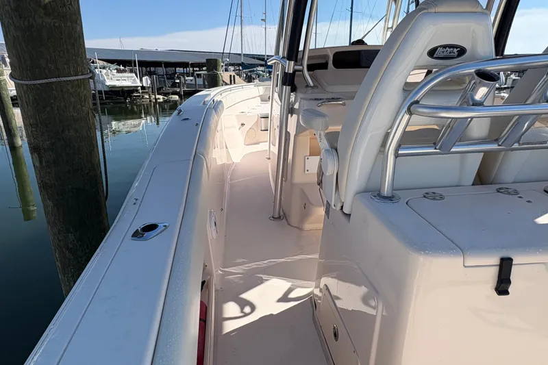 Slide: The Image of 2008 Grady-White Canyon 336 boat interior at marina, showcasing seating and helm. - 13