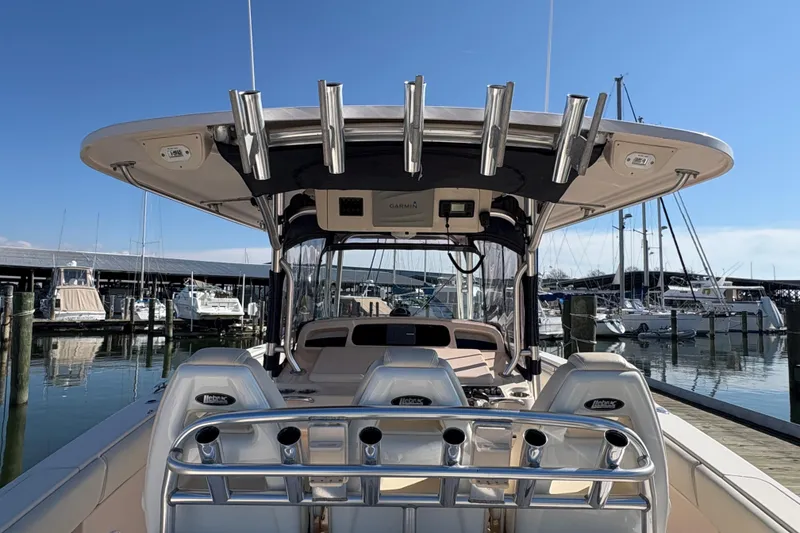 Slide: The Image of 2008 Grady-White Canyon 336 boat docked at marina, featuring fishing rod holders and helm. - 4