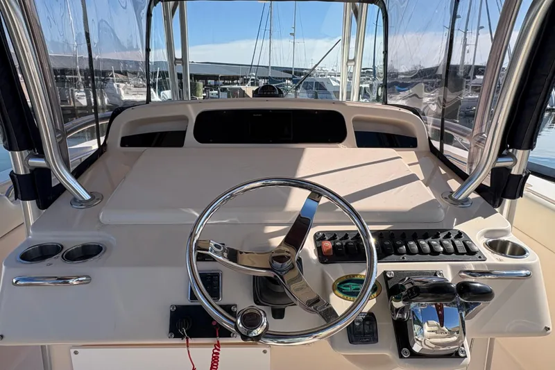 Slide: The Image of 2008 Grady-White Canyon 336 boat helm with steering wheel and control panel. - 7