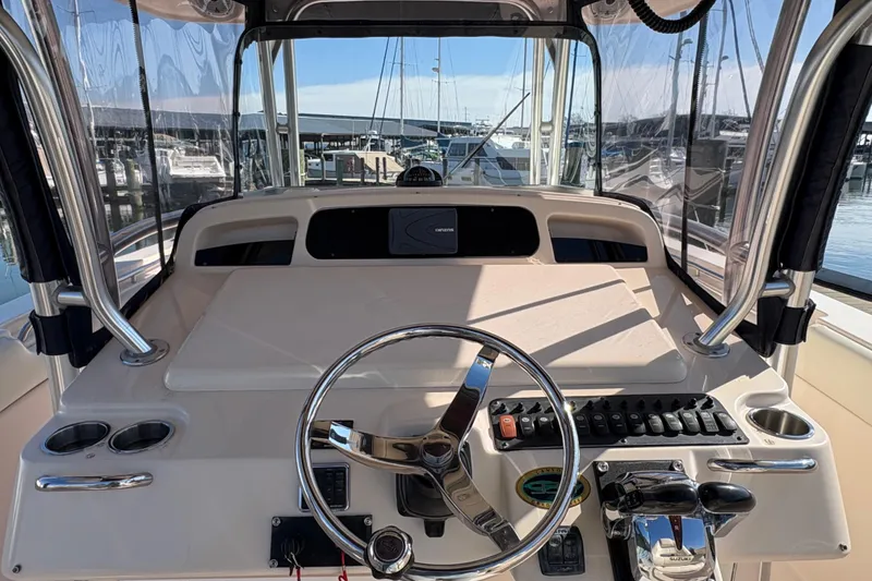 Slide: The Image of 2008 Grady-White Canyon 336 boat helm with steering wheel and control panel. - 8