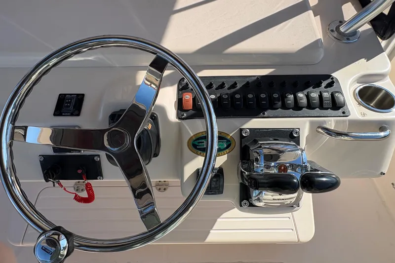 Slide: The Image of Steering console of 2008 Grady-White Canyon 336 boat with controls and switches. - 9