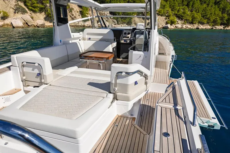 Slide: The Image of Luxurious 2025 Nimbus W11 yacht with spacious deck and elegant seating, cruising in clear waters. - 11