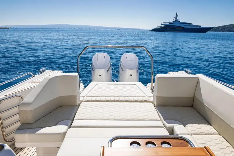 Slide: The Image of Luxury Nimbus W11 boat interior with ocean view, featuring comfortable seating and dual engines, 2025 model. - 14