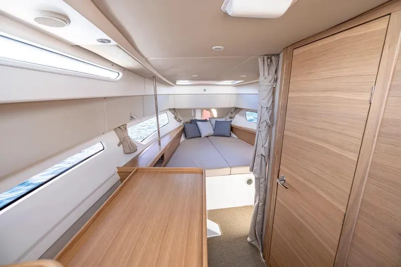 Slide: The Image of Luxurious interior of 2025 Nimbus W11 yacht with cozy bed and wooden finishes. - 23