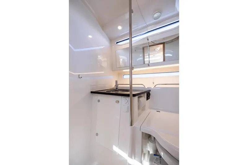 Slide: The Image of Modern interior of 2025 Nimbus W11 yacht, featuring sleek white cabinetry and compact sink area. - 25