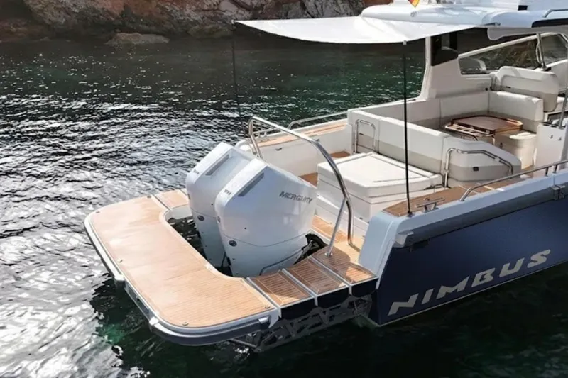 Slide: The Image of Luxury Nimbus W11 2025 yacht with twin Mercury engines on serene water. - 7