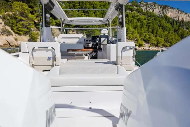 Slide: The Image of Nimbus W11 2025 with dual outboard engines at a boat show. - 12