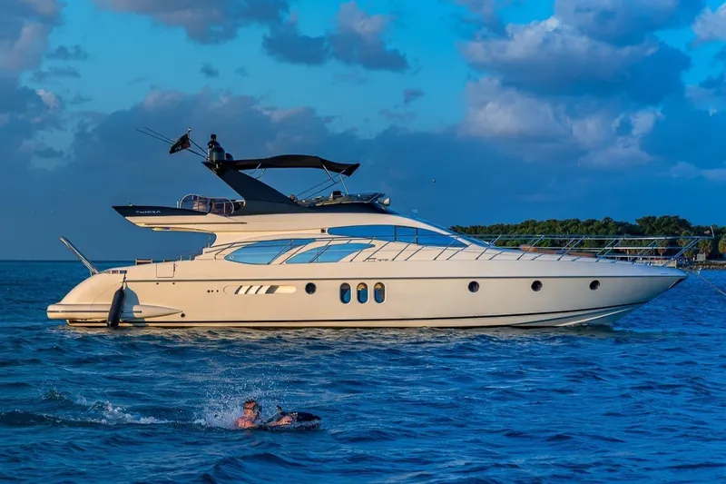 The Image of 2007 Azimut Fly 62 yacht cruising on blue ocean under a vibrant sky. - 1