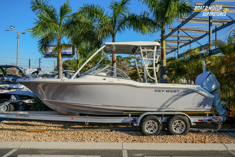 The Image of 2022 Key West 239 DFS boat on trailer, surrounded by palm trees. - 1