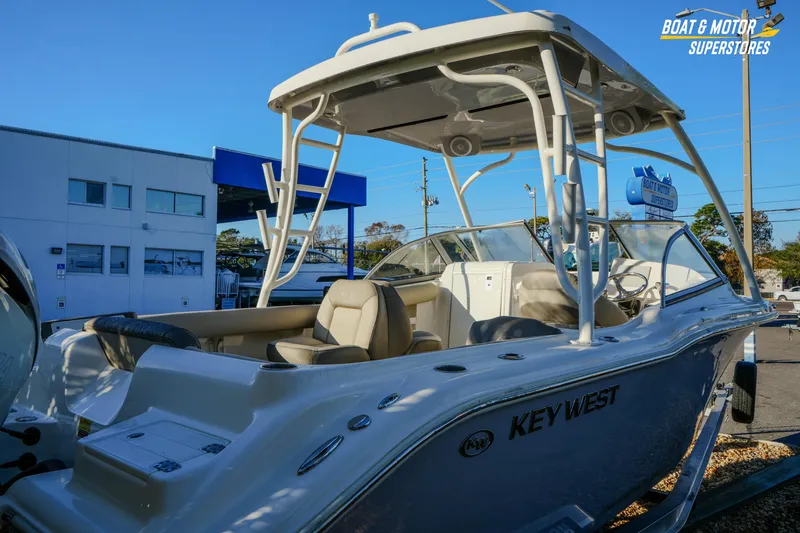 Slide: The Image of 2022 Key West 239 DFS boat displayed at dealership, featuring sleek design and comfortable seating. - 13