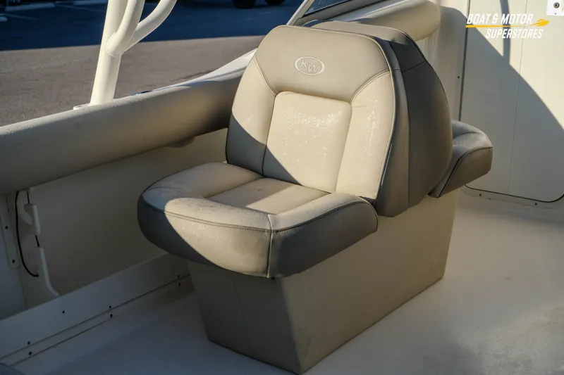 Slide: The Image of 2022 Key West 239 DFS boat seat in sunlight, featuring comfortable gray upholstery. - 17