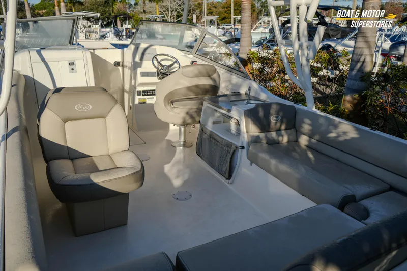 Slide: The Image of 2022 Key West 239 DFS boat interior with seating and steering wheel. - 18