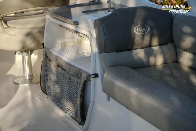 Slide: The Image of 2022 Key West 239 DFS boat interior with cushioned seating and storage compartment. - 20