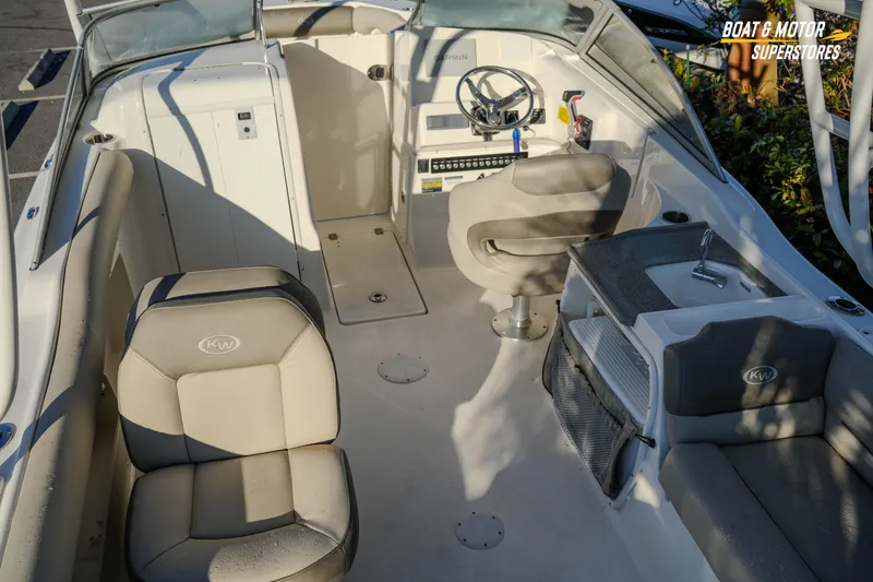 Slide: The Image of 2022 Key West 239 DFS boat interior with seating and steering console. - 22